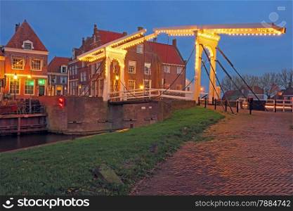 Medieval bridge and houses in the village Enkhuizen The Netherlands by twilight