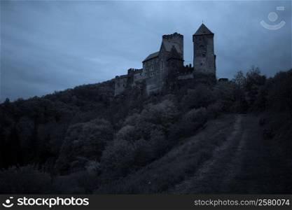 Medieval castle at night with stormy sky