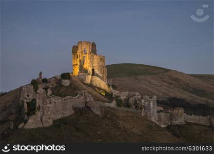 Medieval castle ruins in Autumn landscape at dusk