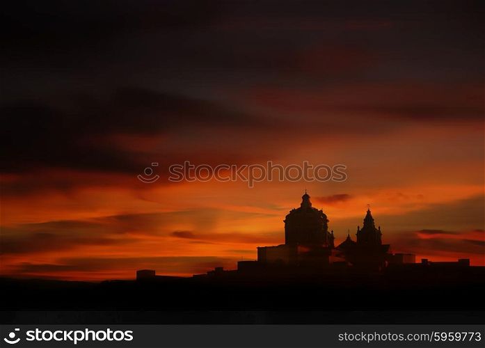 medieval city of Malta in silhouette at sunset