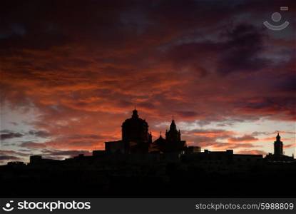 medieval city of Malta in silhouette at sunset