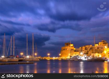 Medieval fortress in Cala Marina, harbor in coastal city Castellammare del Golfo at night, Sicily, Italy. Castellammare del Golfo at sunset, Sicily, Italy