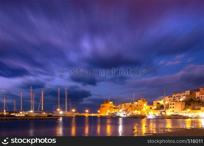Medieval fortress in Cala Marina, harbor in coastal city Castellammare del Golfo at night, Sicily, Italy. Castellammare del Golfo at sunset, Sicily, Italy