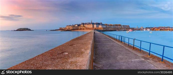 Medieval fortress Saint-Malo, Brittany, France. Panoramic view of walled city Saint-Malo with St Vincent Cathedral at sunset. Saint-Maol is famous port city of Privateers is known as city corsaire, Brittany, France