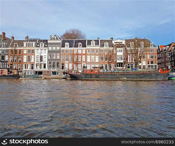 Medieval houses along the river Amstel in Amsterdam Netherlands