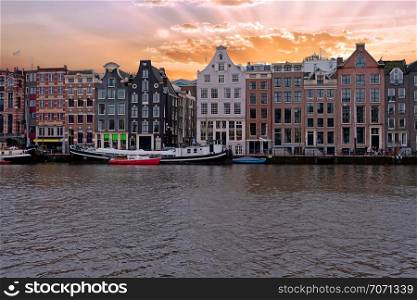 Medieval houses along the river Amstel in Amsterdam Netherlands at sunset
