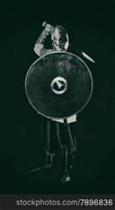 Medieval knight armor with a sword, helmet and shield, black and white image