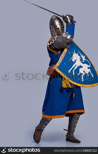 Medieval knight on grey background.