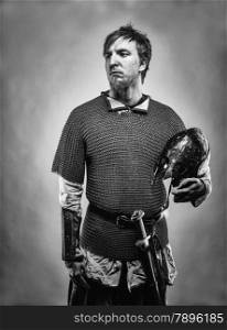 Medieval knight wearing a chainmail, black and white image