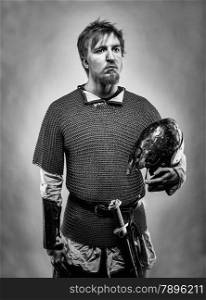 Medieval knight wearing a chainmail, black and white image