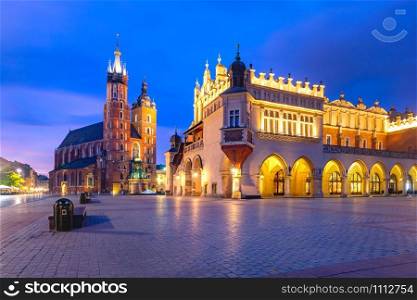 Medieval Main market square with Basilica of Saint Mary and Cloth Hall in Old Town of Krakow at sunrise, Poland. Main market square, Krakow, Poland