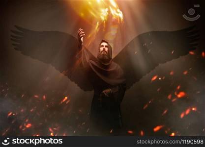 Medieval monk with wings, religion. Mysterious friar flying in dark cape, Mystery and spirituality