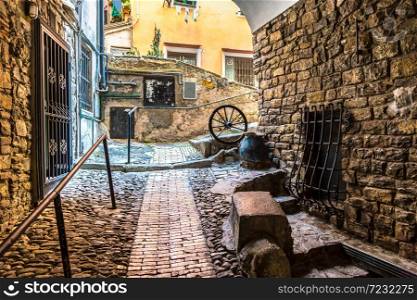 Medieval, old street in San Remo in a beautiful summer day, Italy