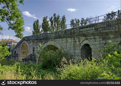 Medieval one hundred meter long stone Kadin bridge build over the river Struma, Nevestino village, Bulgaria