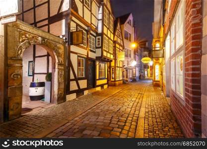 Medieval street Schnoor in Bremen, Germany. Medieval Bremen street Schnoor with half-timbered houses in the centre of the Hanseatic City of Bremen at night, Germany