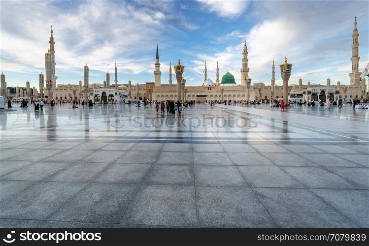 MEDINA, KINGDOM OF SAUDI ARABIA (KSA) - FEB 1: Muslims marching in front of the mosque of the Prophet Muhammad on February 1, 2017 in Medina, KSA. Prophet's tomb is under the green dome.