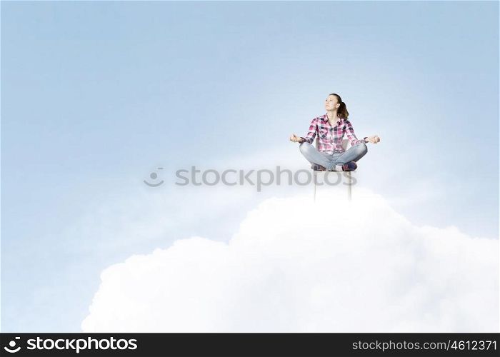 Meditation concept. Young woman sitting on chair and meditating