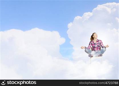 Meditation concept. Young woman sitting on chair and meditating