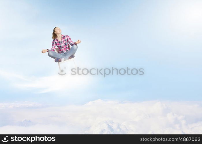 Meditation concept. Young woman sitting on chair and meditating