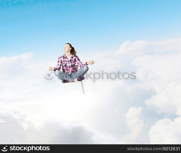 Meditation concept. Young woman sitting on chair and meditating