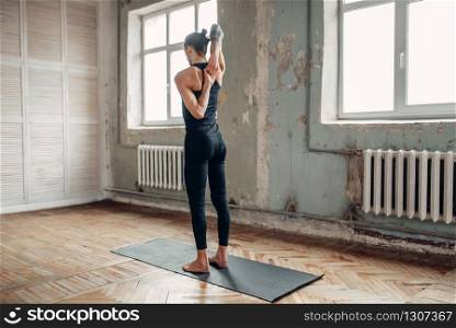 Meditation in yogi studio, full concentration. Yoga with tattoo doing balance exercise on mat in gym with grunge interior.. Meditation in yogi studio, full concentration