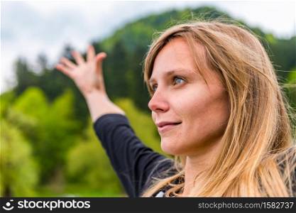 Meditation. Positive young woman meditating outdoors