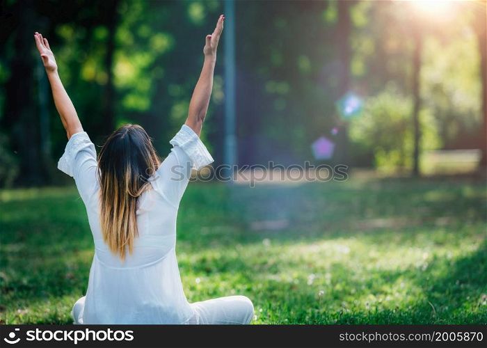 Meditation. Young woman practicing yoga and meditating by the water.. Meditation by the water