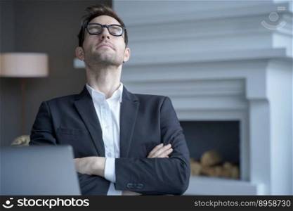 Meditative german businessman in formal wear relaxing at workplace in office with arms crossed over chest, throwing head back and closing his eyes. Tired employee taking rest from remote computer work. Mediative german businessman sit at desk with eyes closed taking rest from computer work