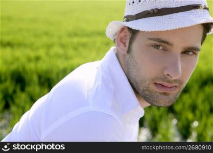 Mediterranean man portrait white hat in green meadow rice field