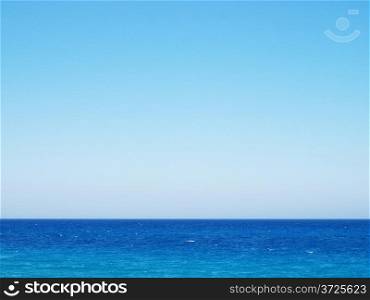 Mediterranean Sea. Clear wavy water surface and clear blue sky.