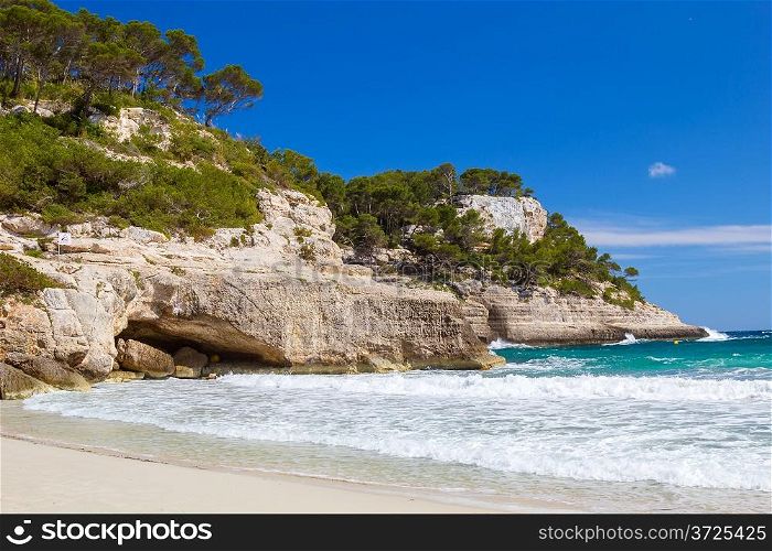 Mediterranean sea cliffs at Cala Mitjana beach at Menorca island, Spain.