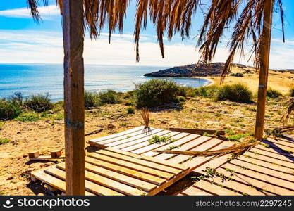 Mediterranean sea coast landscape, beach with shelter made of palm leaves, Murcia region, Calblanque Regional Park in Spain.. Beach sea shore. Coast in Murcia Spain.