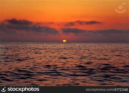 Mediterranean sea sunrise sunset with sun in red sky