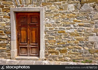 Mediterranean style wooden door on stone wall, architecture detail view