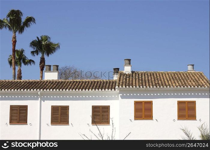 mediterranean white house outdoor detail blue sky palm trees