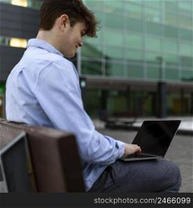 medium shot boy working laptop