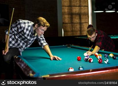 medium shot boys playing billiard together