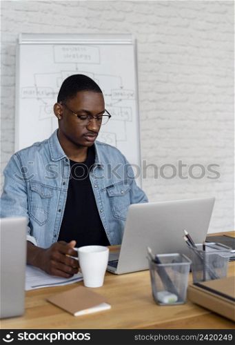 medium shot business man working laptop