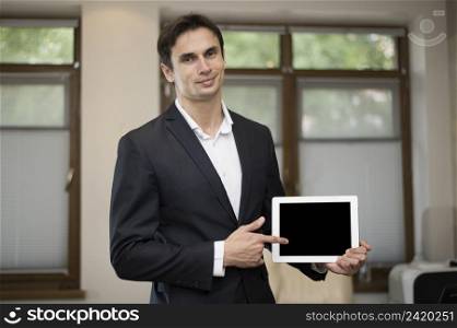 medium shot businessman holding tablet