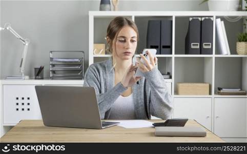 medium shot businesswoman holding phone