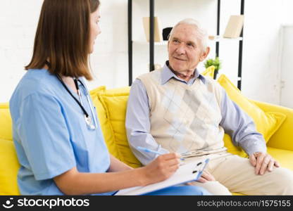 medium shot caregiver talking old man