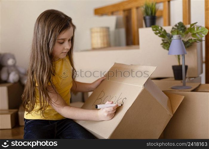 medium shot cute girl writing box