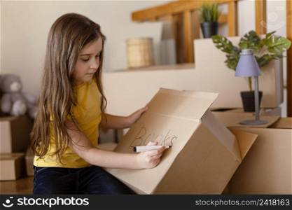 medium shot cute girl writing box