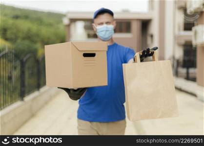 medium shot delivery man holding box bag