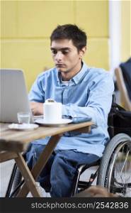 medium shot disabled man working laptop