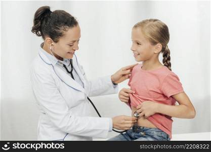 medium shot doctor checking girl s abdomen