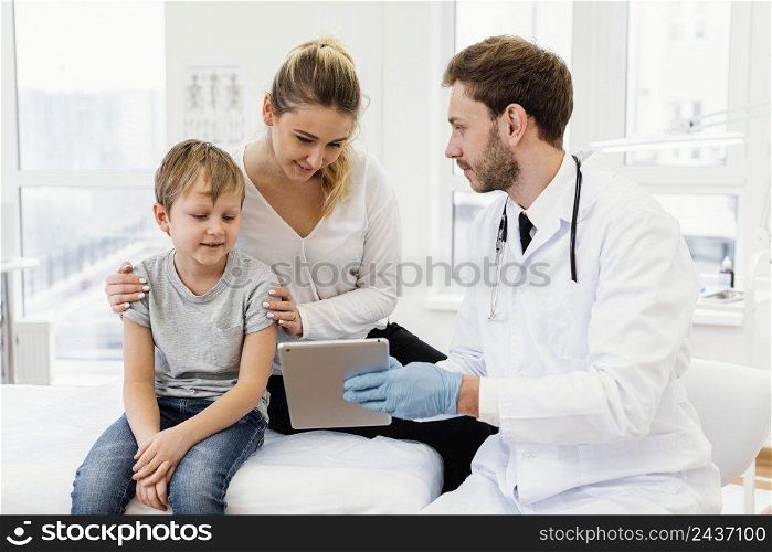 medium shot doctor holding tablet
