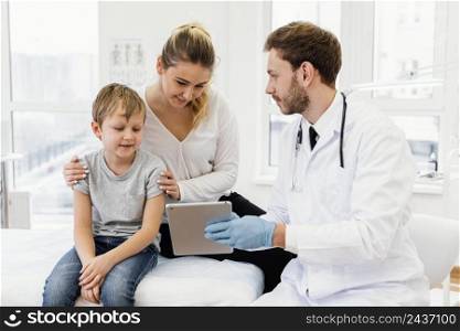 medium shot doctor holding tablet