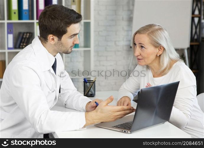 medium shot doctor patient discussing