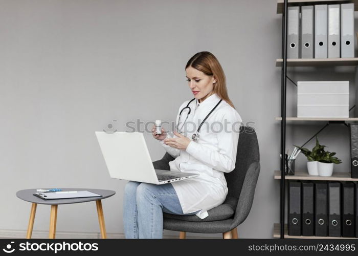 medium shot doctor sitting with computer